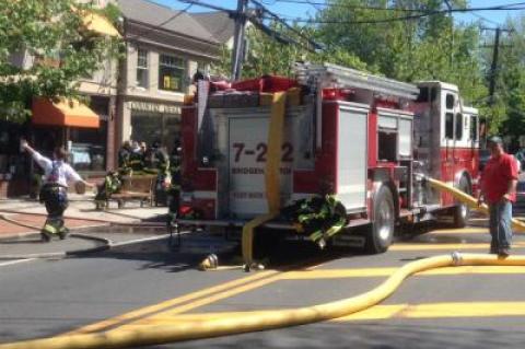 Firefighters on Montauk Highway in Bridgehampton, which was closed to traffic on Saturday morning as a fire at World Pie restaurant was brought under control.