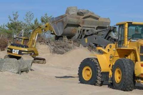 Workers placed boulders in front of a Georgica Beach property Wednesday while a lawyer for the East Hampton Town Trustees sought a court injunction to stop them.