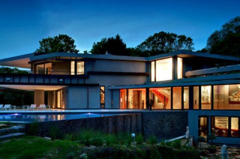 A sunken courtyard off the lower level and cantilevered overhangs off the library and master bedroom, add outdoor living space.