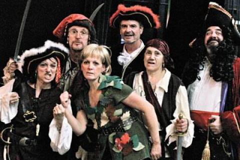 Jayne Freedman, surrounded by pirates, including Josh Gladstone’s Captain Hook (far right), plays Peter Pan in the Springs Community Theater production tomorrow and Saturday at Guild Hall.